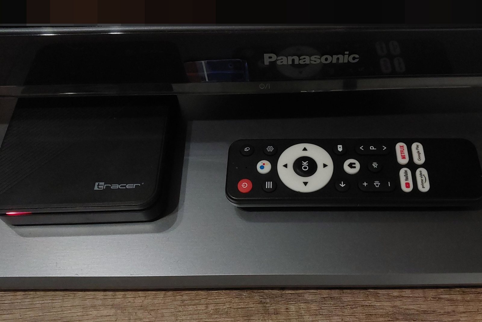An Android TV set-top box with its remote control