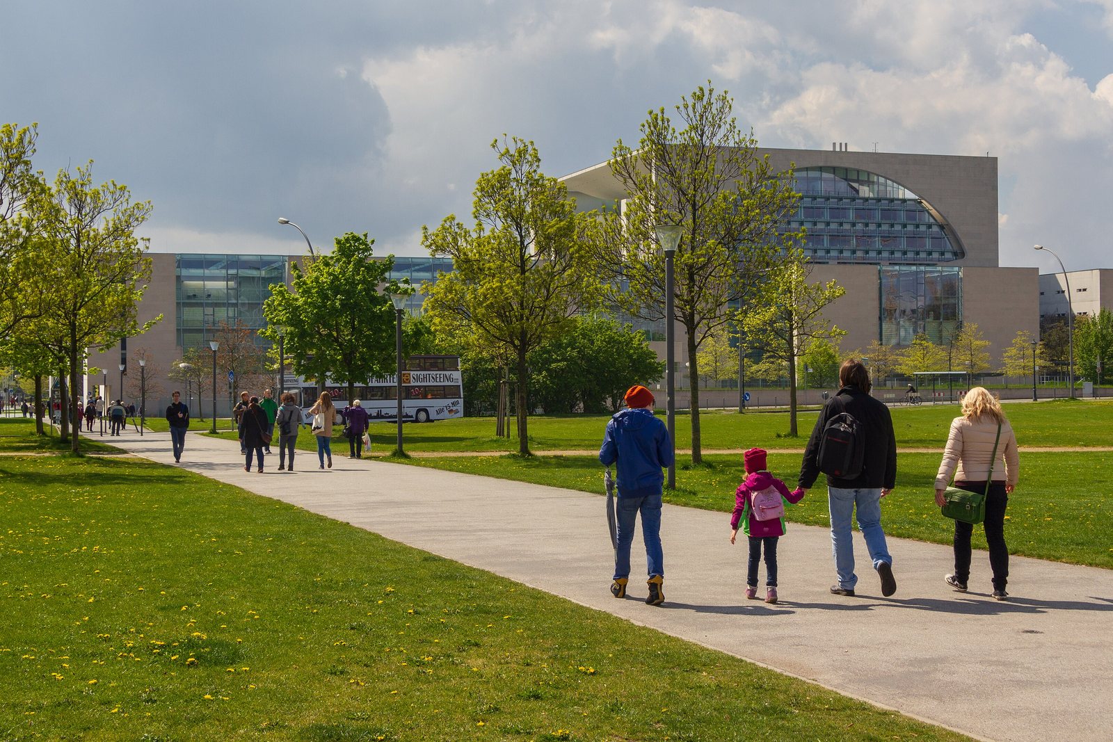 People walking past the German Chancellery in Berlin on a sunny day
