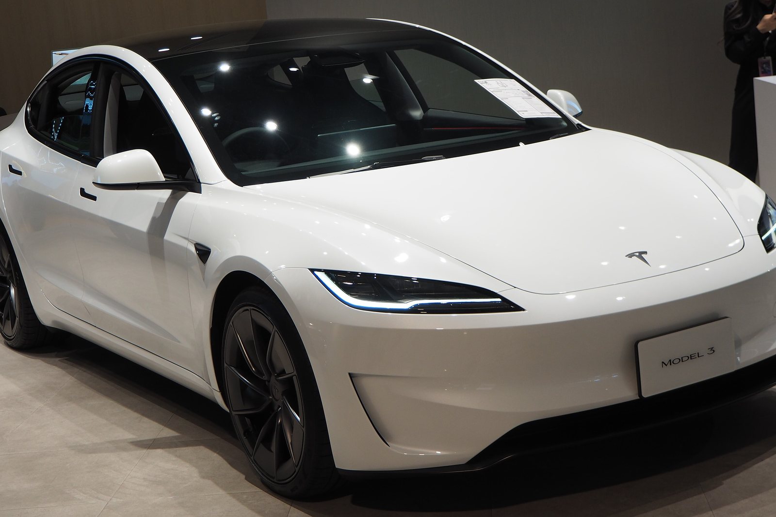 A white 2024 Tesla Model 3 Performance on display